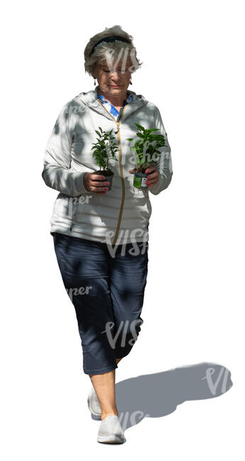 cut out senior woman with plants walking in the garden