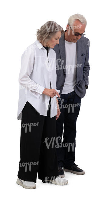 senior couple standing and looking down at smth
