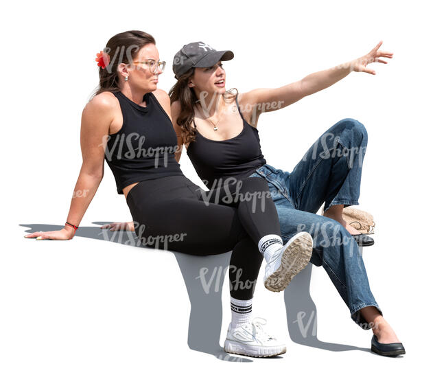 two women sitting outside and looking at smth