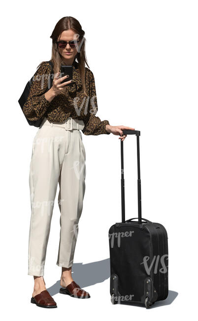 cut out woman with a suitcase standing and checking her phone