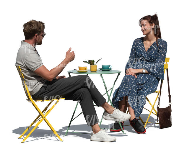 two people sitting in an outdoor hipster cafe