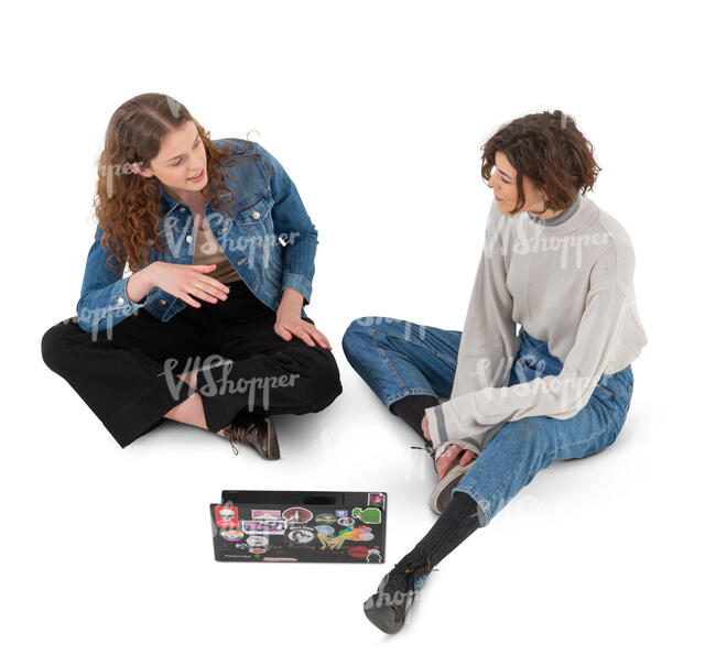 top view of two women sitting on the ground and studying