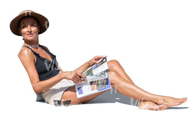 cut out woman lying on a sofa in the sun and reading a magazine 
