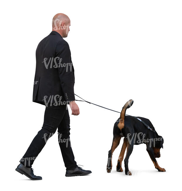 cut out man in a black suit walking a dog