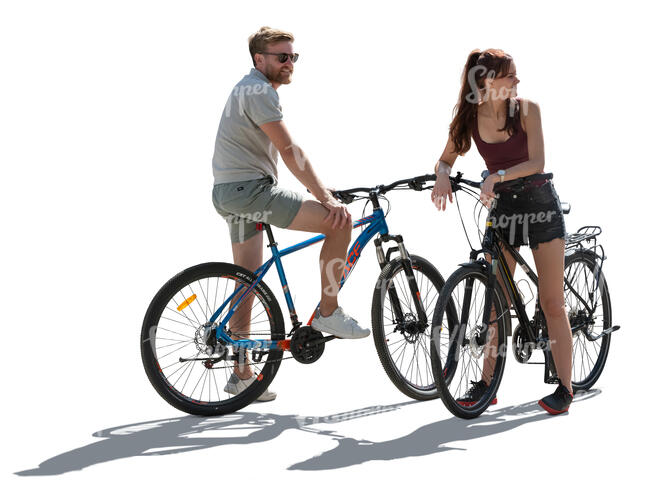 backlit man and woman with bikes stopping and looking around