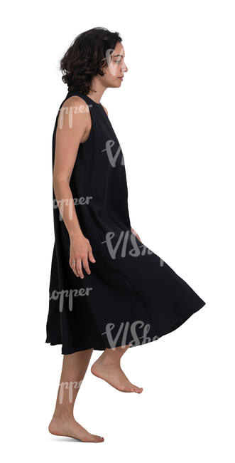 woman in a black dress walking up the stairs at home barefoot