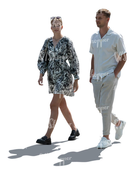 backlit man and woman walking