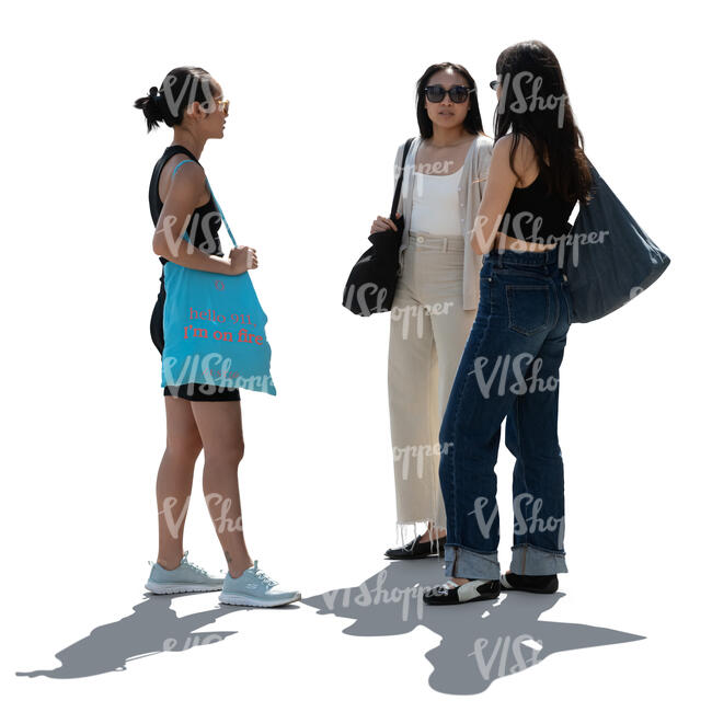 three women standing in backlight