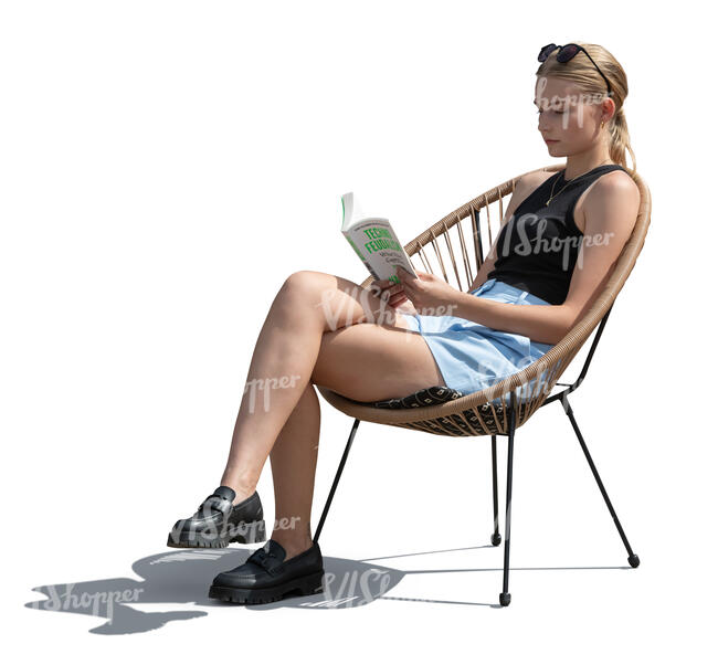 woman sitting in an armchair and reading