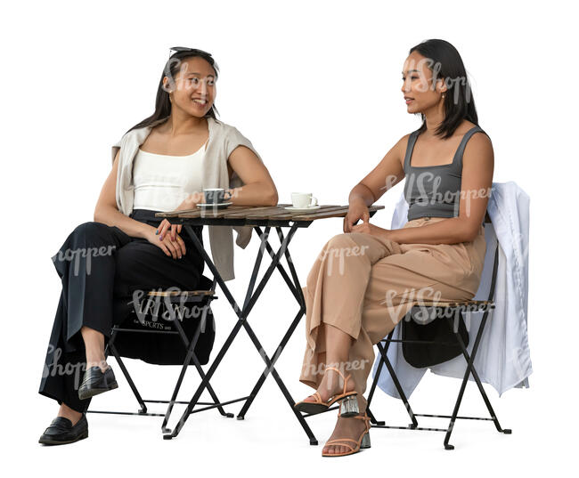 two young asian women sitting in a cafe