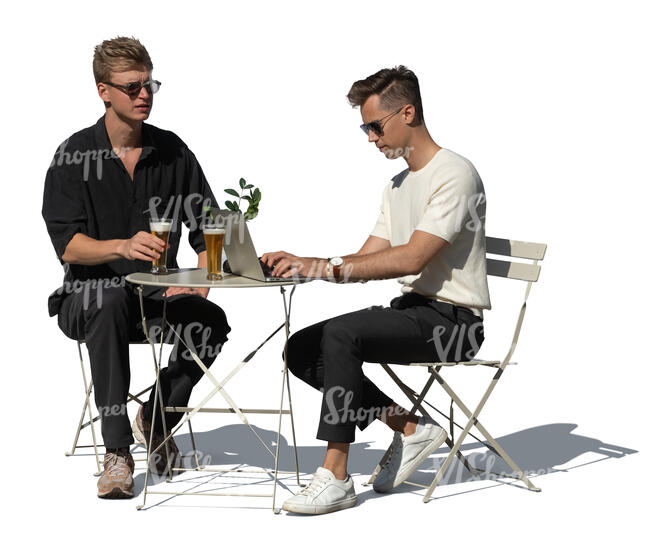 two cut out men sitting in an outdoor cafe and drinking beer
