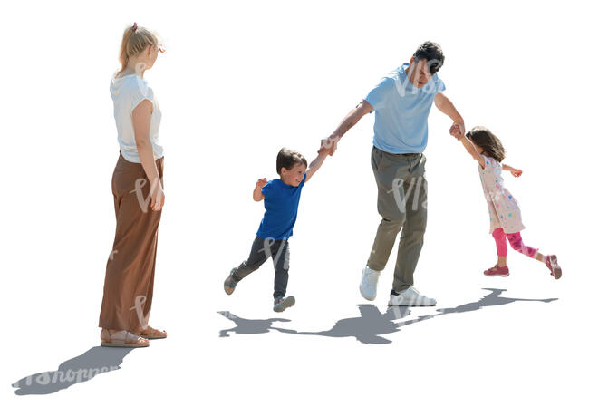 backlit scene of a father playing with children and mom watching