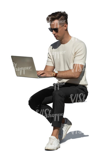 cut out man sitting outside and working with a laptop
