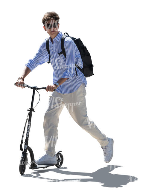 cut out backlit teenage boy riding a scooter