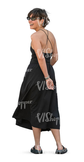 woman in a black dress standing and looking back