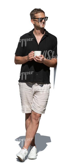 man leaning on a doorway and drinking coffee