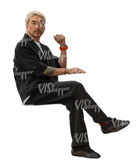 asian man in a casual suit sitting at a table