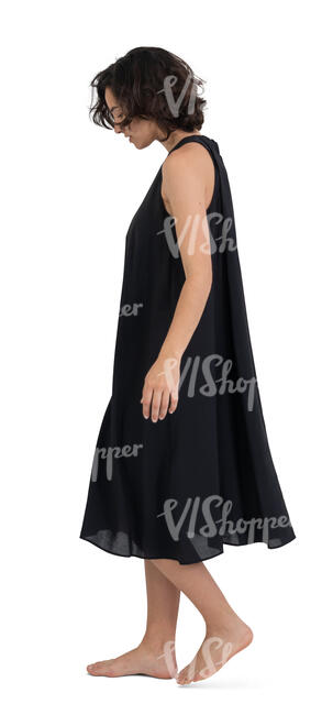 woman in a black dress and barefoot walking at home