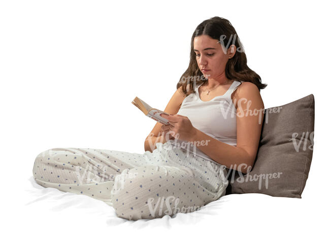 cut out woman in her pajamas sitting on the bed and reading