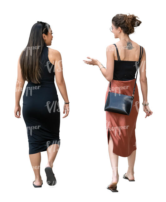 two women in dresses walking and talking