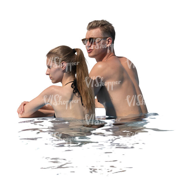 man and woman looking over a pool edge