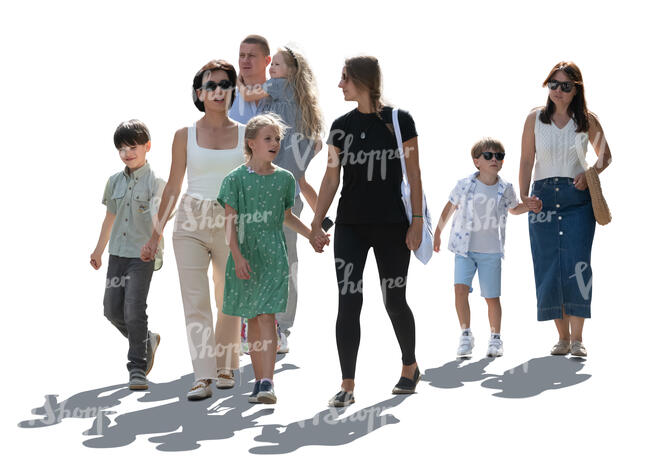 backlit group of adults and kids walking