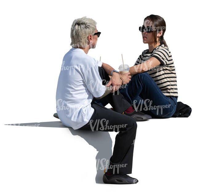 man and woman sitting outside and drinking ice coffees