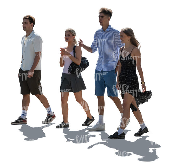 backlit group of teenage boys and girls walking