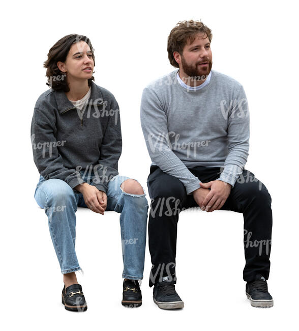two people sitting and looking at smth