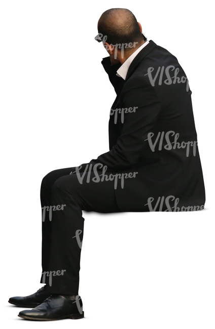 businessman man in a black suit sitting