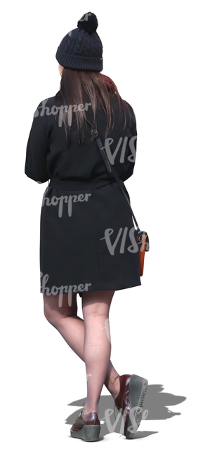 woman wearing a black coat and hat standing
