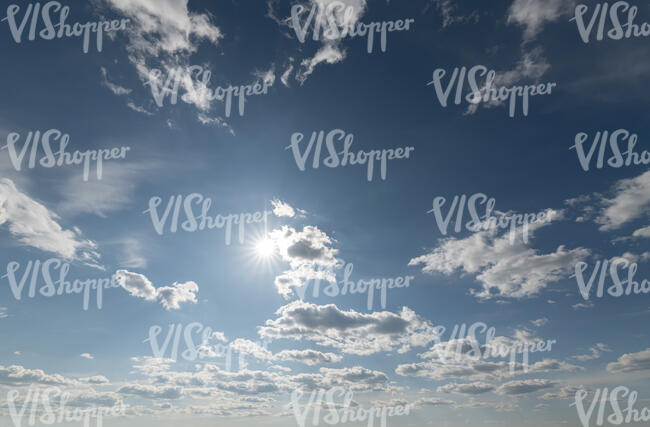 bright sky with sun and small clouds